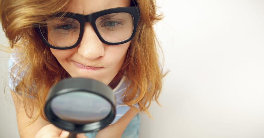 image of woman with magnifying glass