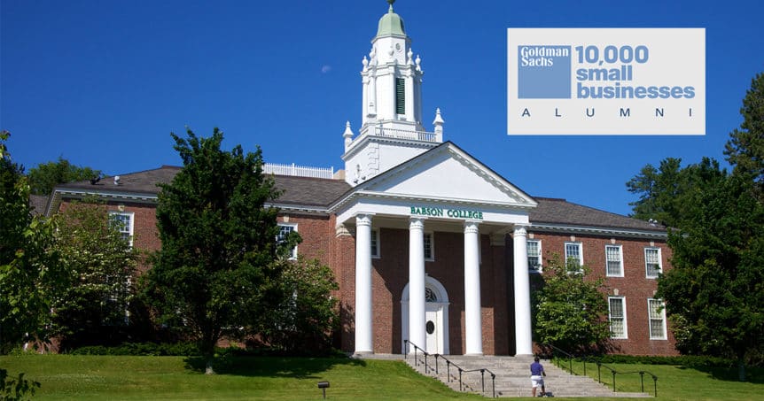 Image of Babson College with man walking up steps on a sunny day with Goldman Sachs logo