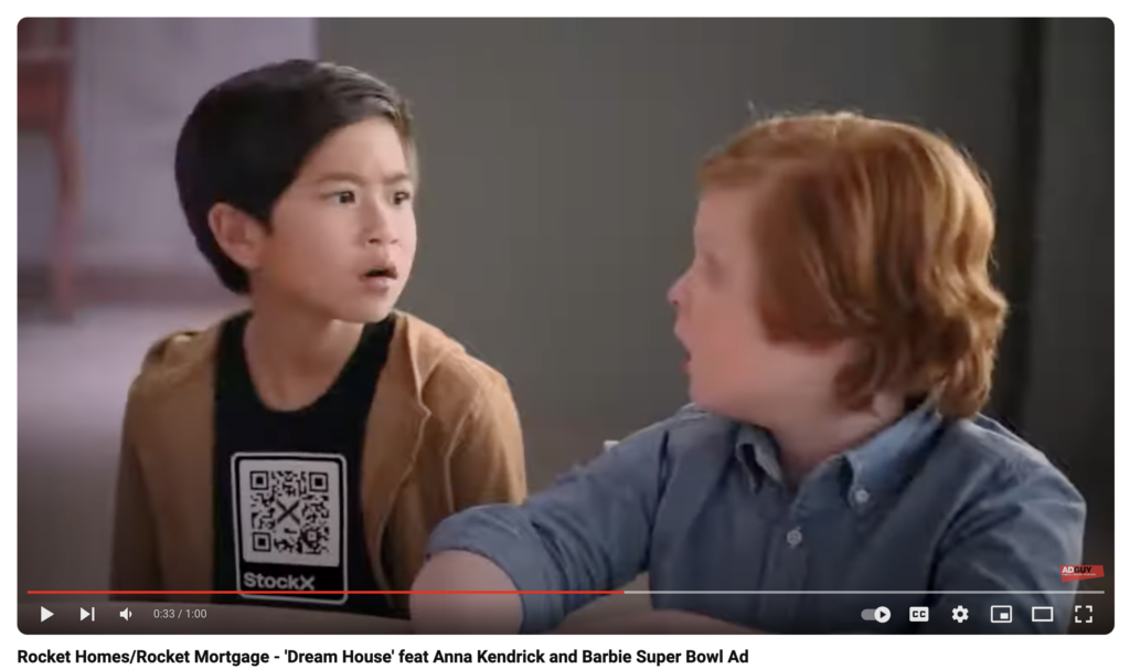 Image: Screenshot showing a character in a video wearing a tee shirt with a QR code for Rocket Morgage.