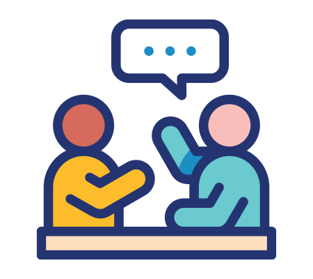 Two people engaged in conversation at a table with a speech bubble above them