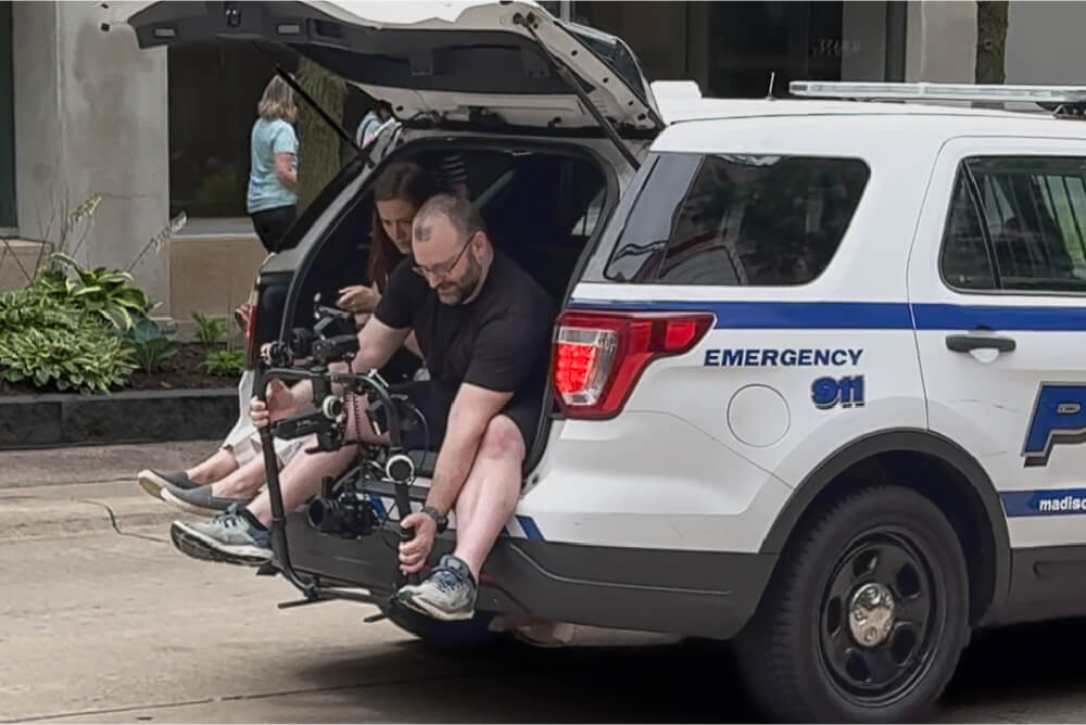 Behind-the-scenes view of The Creative Company’s videography team filming the Madison Police Department video campaign on State Street in Madison, WI.